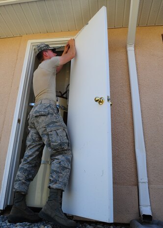Airman 1st Class Steven Brent, 9th Civil Engineer Squadron structural assurance technician, installs a storm chain in housing at Beale Air Force Base Calif., Sept. 19, 2012. 9th CES is working to complete final repairs to the Mountain View neighborhood before transferring the buildings to privatized housing contractors.  (U.S. Air Force photo by Senior Airman Shawn Nickel/released)