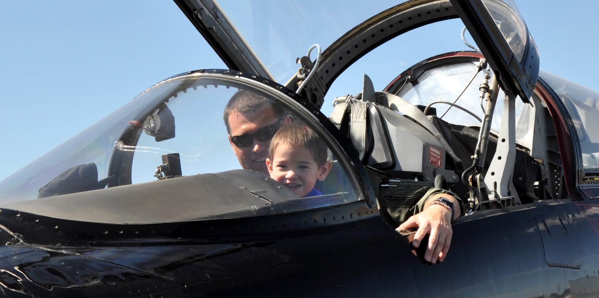 A child becomes a pilot-for-a-day in an Air Force T-38 Talon trainer aircraft during the National Championship Air Races at Stead Airport, Reno, Nev., Sept. 14, 2012. The Talon is primarily used by Air Education and Training Command for joint specialized undergraduate pilot training. (U.S. Air Force photo by Staff Sgt. Robert M. Trujillo/Released)