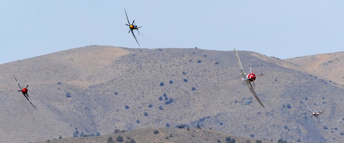 Several vintage fighter aircraft race for position during the 49th Annual National Championship Air Races at Stead Airport, Reno, Nev., Sept. 14, 2012. Aircraft often reach speeds of more than 400 mph. (U.S. Air Force photo by Staff Sgt. Robert M. Trujillo/Released)