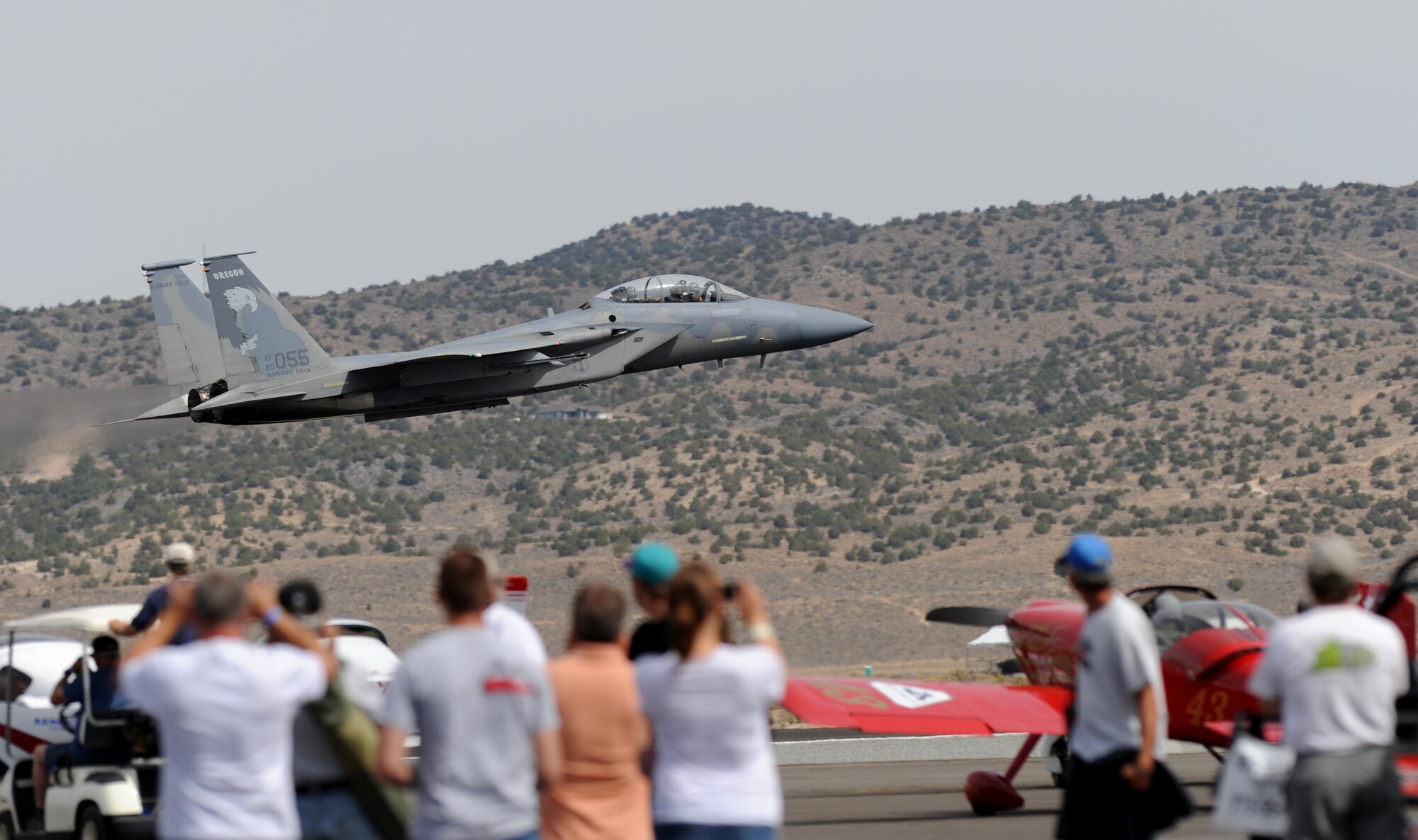 A U.S. Air Force F-15 Eagle fighter aircraft flies by a group of spectators during the National Championship Air Races at Stead Airport, Reno, Nev., Sept. 14, 2012. The aircraft is from the 114th Fighter Squadron, Oregon Air National Guard. (U.S. Air Force photo by Staff Sgt. Robert M. Trujillo/Released)