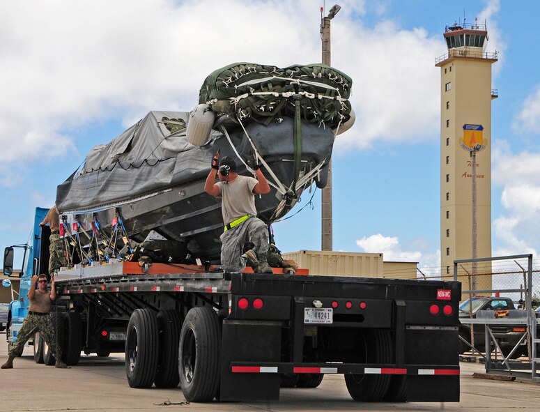 ANDERSEN AIR FORCE BASE, Guam  -- Air Force and Navy personnel work together to make sure that Navy assets are loaded properly on an Air Force trailer on the flightline here, Sept. 11. The coordination to transport valuable assets is one among many ways Andersen and Naval Base Guam work together in order to accomplish their mission as part of Joint Region Marianas. (U.S. Air Force photo by Airman 1st Class Marianique Santos/Released)