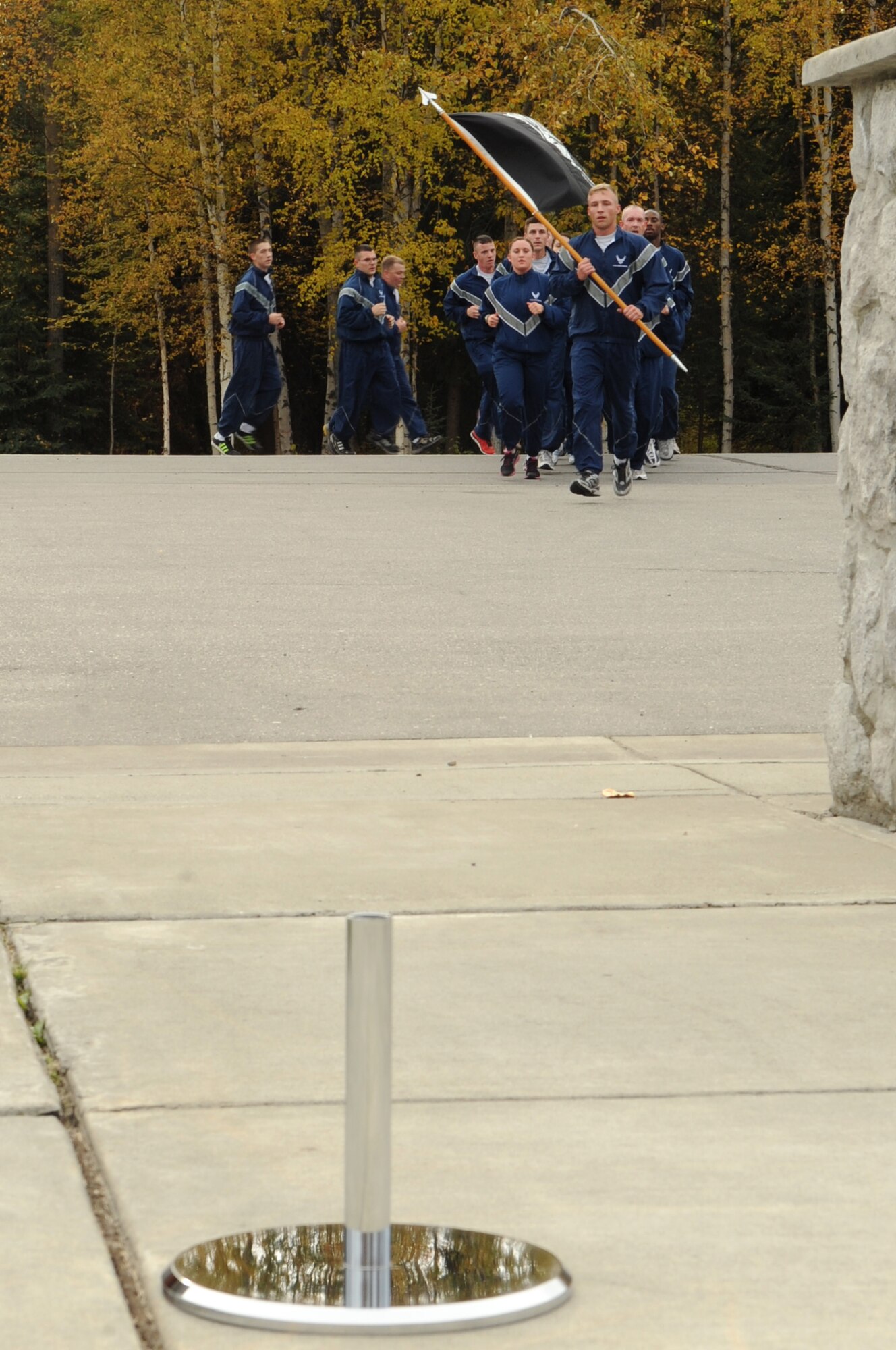 Airmen assigned to the 354th Logistics Readiness Squadron run to Heritage Park during the final segment of a 24-hour POW/MIA run Sept. 14, 2012, Eielson Air Force Base, Alaska. Senior Airman Cody Freeland, 354th LRS, posted the POW/MIA flag for the rendering of military honors. (U.S. Air Force photo/Airman 1st Class Lauren-Taylor Garcia)