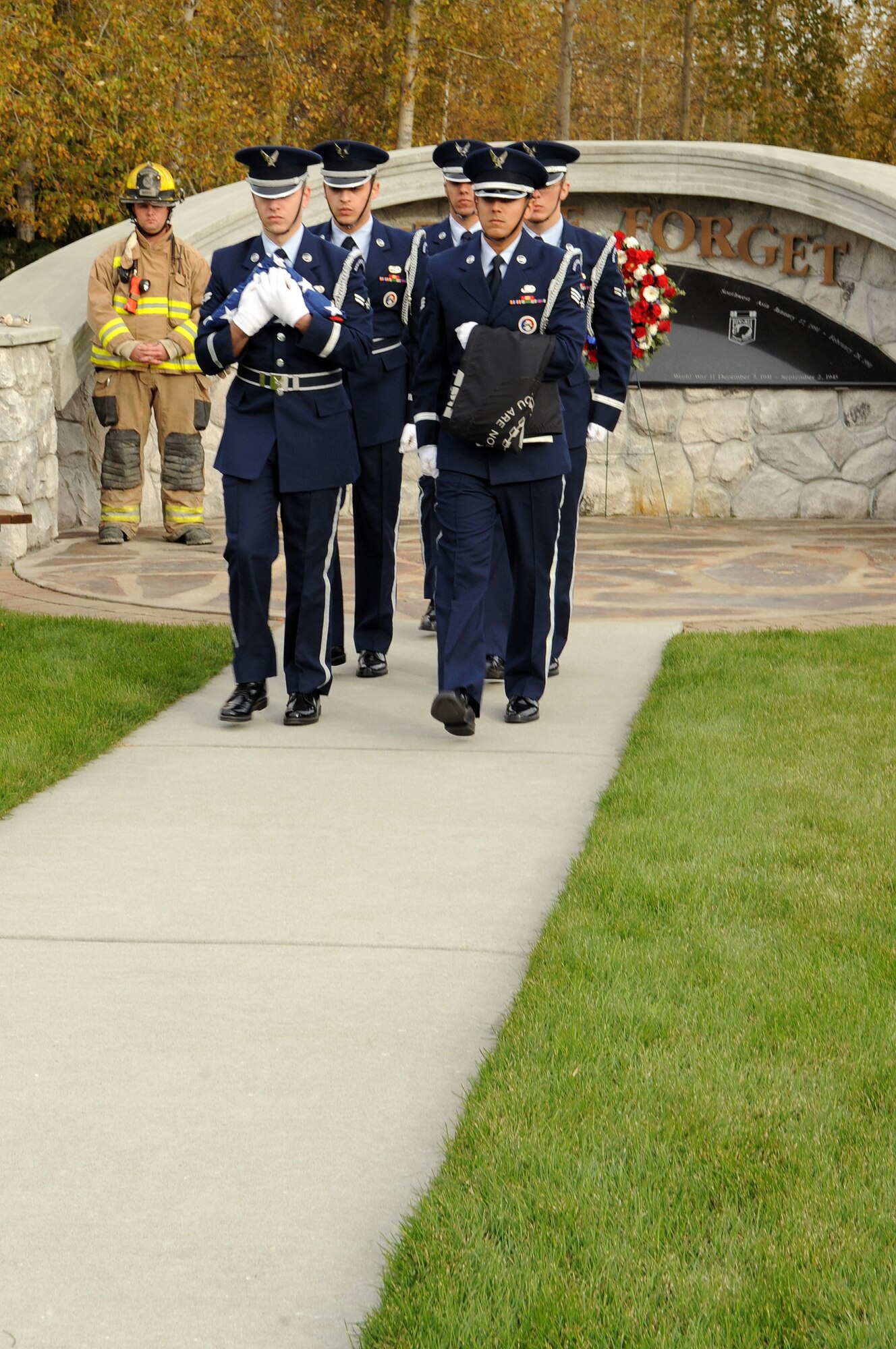 Eielson Air Force Base honor guard members march with the American flag and the POW/MIA flag during a POW/MIA retreat ceremony at Heritage Park, Sept. 14, 2012, Eielson AFB, Alaska. The POW/MIA flag is a symbol of citizen concern about U.S. military personnel taken as prisoners of war or listed as missing in action. (U.S. Air Force photo/Airman 1st Class Lauren-Taylor Garcia)