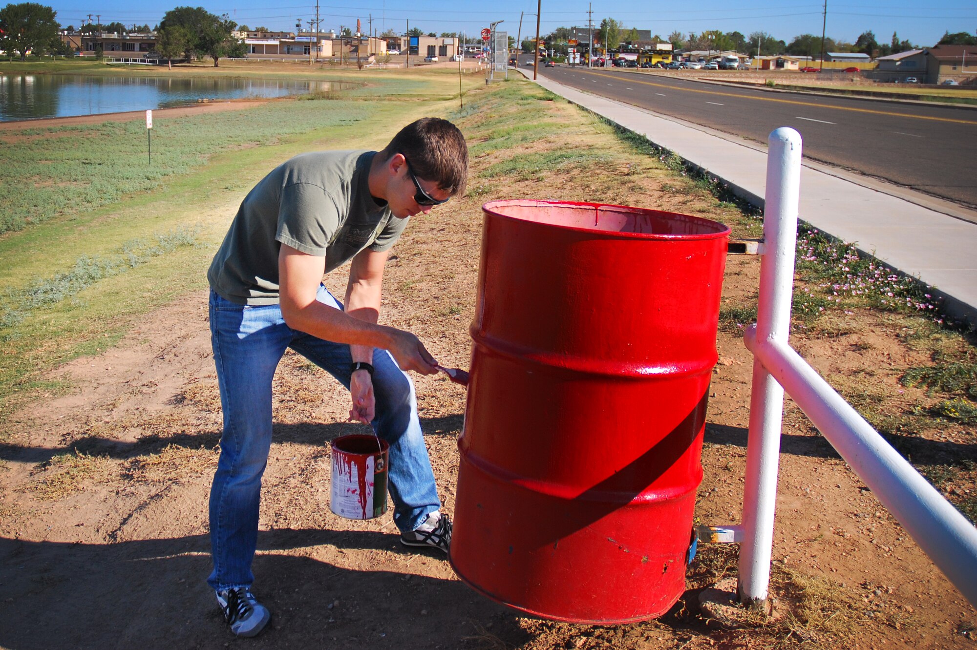 An Air Commando stationed at Cannon Air Force Base, N.M., provides a fresh coat of paint to a park receptacle as part of a beautification project at Green Acres Park in Clovis, N.M., Sept. 15, 2012. Clovis Parks and Recreations provided the Cannon volunteers with paint, brushes, protective work gear and refreshments for their efforts within the community. (U.S. Air Force photo/Airman 1st Class Alexxis Pons Abascal)  
