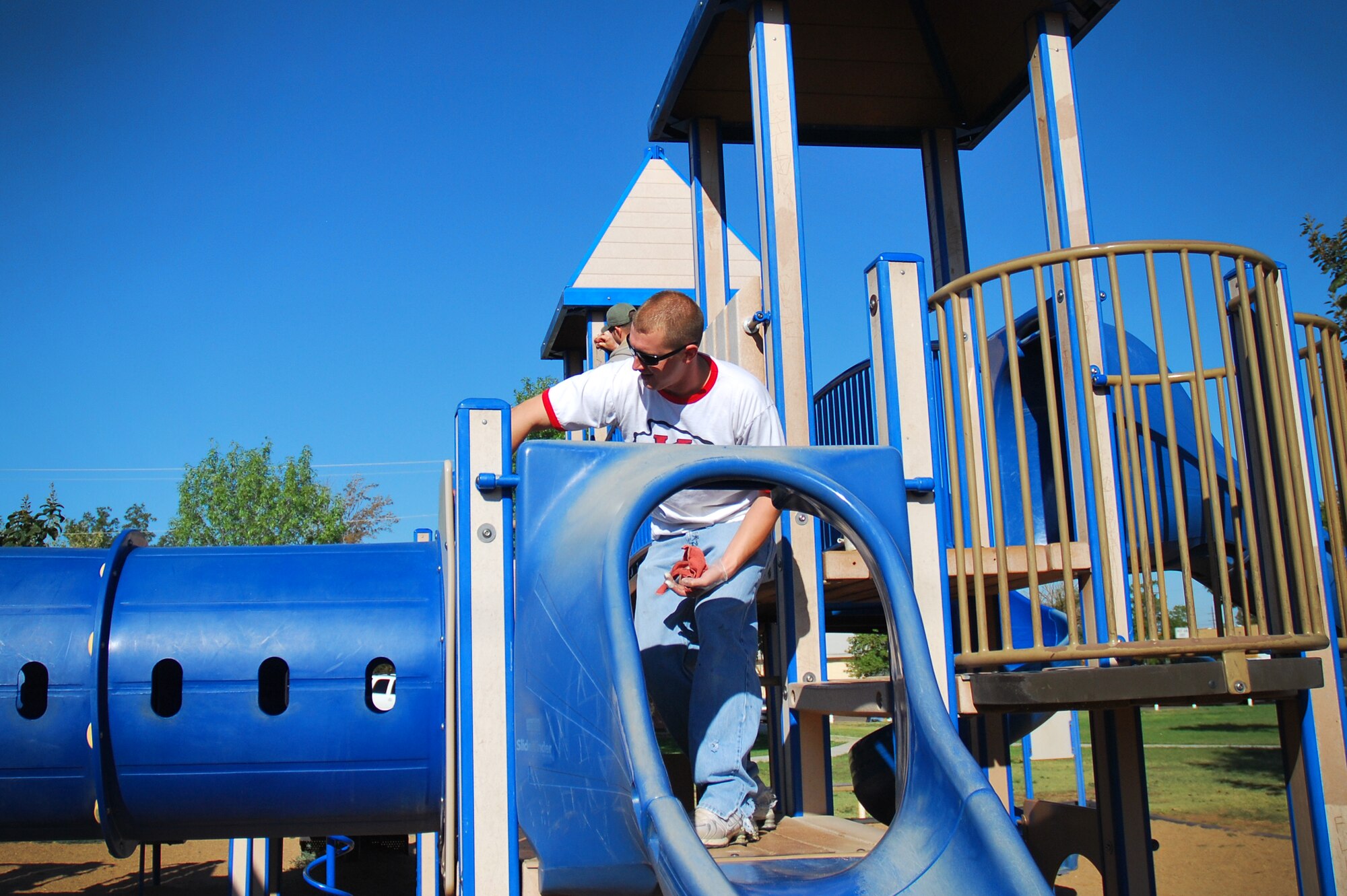 An Air Commando stationed at Cannon Air Force Base, N.M., cleans playground equipment as part of a beautification project at Green Acres Park in Clovis, N.M., Sept. 15, 2012. Clovis Parks and Recreations provided the Cannon volunteers with paint, brushes, protective work gear and refreshments for their efforts within the community. (U.S. Air Force photo/Airman 1st Class Alexxis Pons Abascal)  