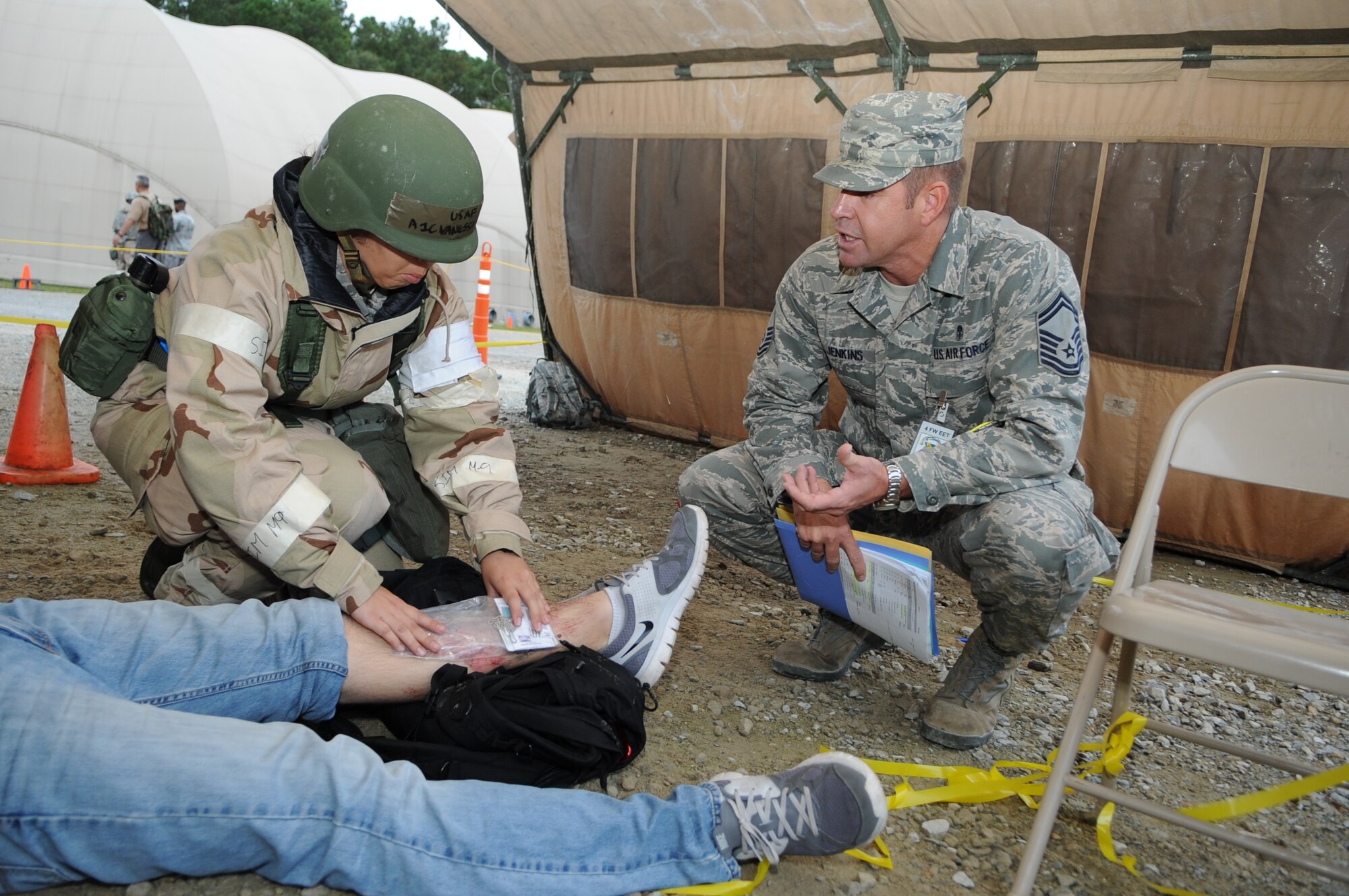 U.S. Air Force Airman 1st Class Vanessa Brown, 4th Medical Operations Squadron medical technician, is questioned by Senior Master Sgt. Michael Jenkins, 4th Medical Operations Squadron superintendant, during Phase II of Operational Readiness Exercise Coronet Warrior 12-4 at a simulated deployed location on Seymour Johnson Air Force Base, N.C., Sept 19, 2012. Medical personnel are tested on their ability to treat patients by using self aid buddy care while deployed. (U.S. Air Force photo/Airman 1st Class Aubrey Robinson/Released)
