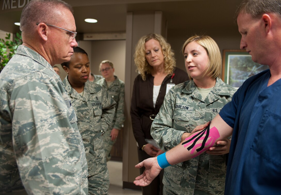 Senior Airman Haylley Carlson, 28th Medical Operations Squadron physical therapy technician, explains her certification in kinesio taping to Brig. Gen. Daniel Wyman, Air Combat Command command surgeon at Ellsworth Air Force Base, S.D., Sept. 18, 2012. Carlson’s certification allows Ellsworth’s medical team to apply kinesio tape to any stage of injury to relieve pain and prevent injury. (U.S. Air Force photo by Airman 1st Class Alystria Maurer/Released)