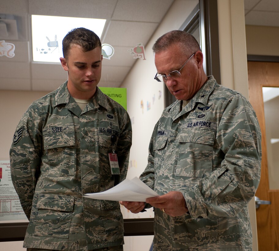 Brig. Gen. Daniel Wyman, Air Combat Command command surgeon, discusses chest pain protocol with Staff Sgt. Jason Stee, 28th Medical Operations Squadron medical technician at Ellsworth Air Force Base, S.D., Sept. 18, 2012. Wyman came to visit and become more familiar with the Ellsworth medical team’s objectives and mission. (U.S. Air Force photo by Airman 1st Class Alystria Maurer/Released)