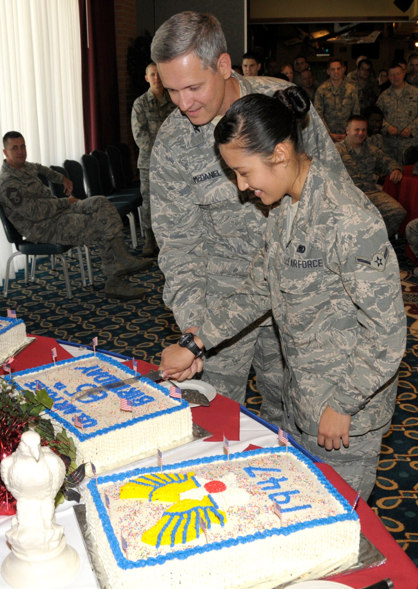 Col. Michael McDaniel, left, 71st Mission Support Group commander, and Airman Shalimar Martinez, 71st Logistics Readiness Squadron, cut the cake during a celebration of the U.S. Air Force’s 65th birthday held Sept. 18 in the Collocated Club at Vance AFB, Okla. McDaniel and Martinez represented the senior and junior ranking members at the celebration. (U.S. Air Force photo/ Roger Betz)  