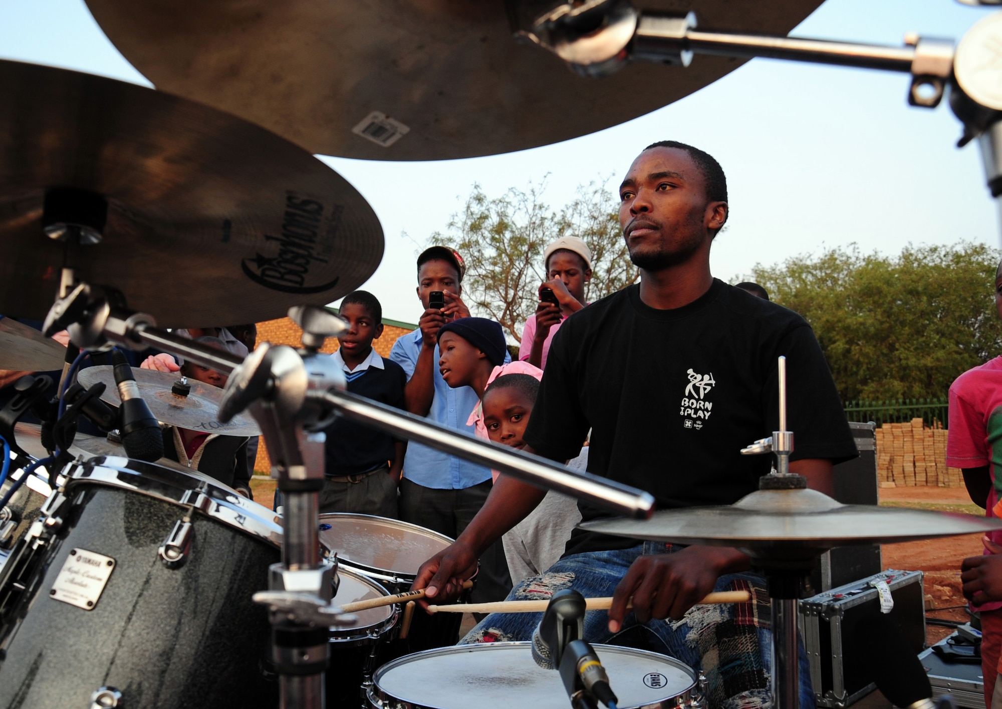 CULLINAN, South Africa -- Boy Boshiane, Field Band Foundation band coordinator, plays the drums after a performance by the U.S. Air Forces in Europe rock band, Touch 'n Go here, Sept. 18. The Field Band Foundation is a private organization that has a goal of educating children within the local community on making good decisions, creativity, music and dance and other important life skills. The foundation aims to keep children away from negative influences and encourage them to be successful in life. (U.S. Air Force photo by Staff Sgt. Debbie Lockhart)