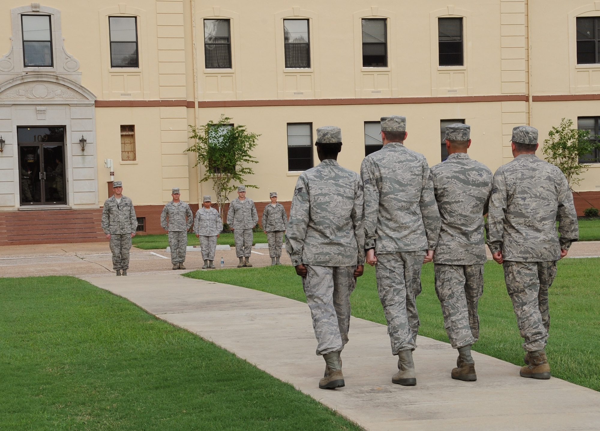Airmen from Airman Leadership School class 12-6 march toward Col. Alexis Mezynski, 2nd Bomb Wing vice commander, during a retreat ceremony on Barksdale Air Force Base, La., Sept. 18. After the flag is folded, the flag detail reports to the commander. ALS Airmen performed retreat in honor of the Air Force's 65th birthday. This was the first time an ALS class performed retreat for the 2nd Bomb Wing. (U.S. Air Force photo/Airman 1st Class Benjamin Gonsier)(RELEASED)

