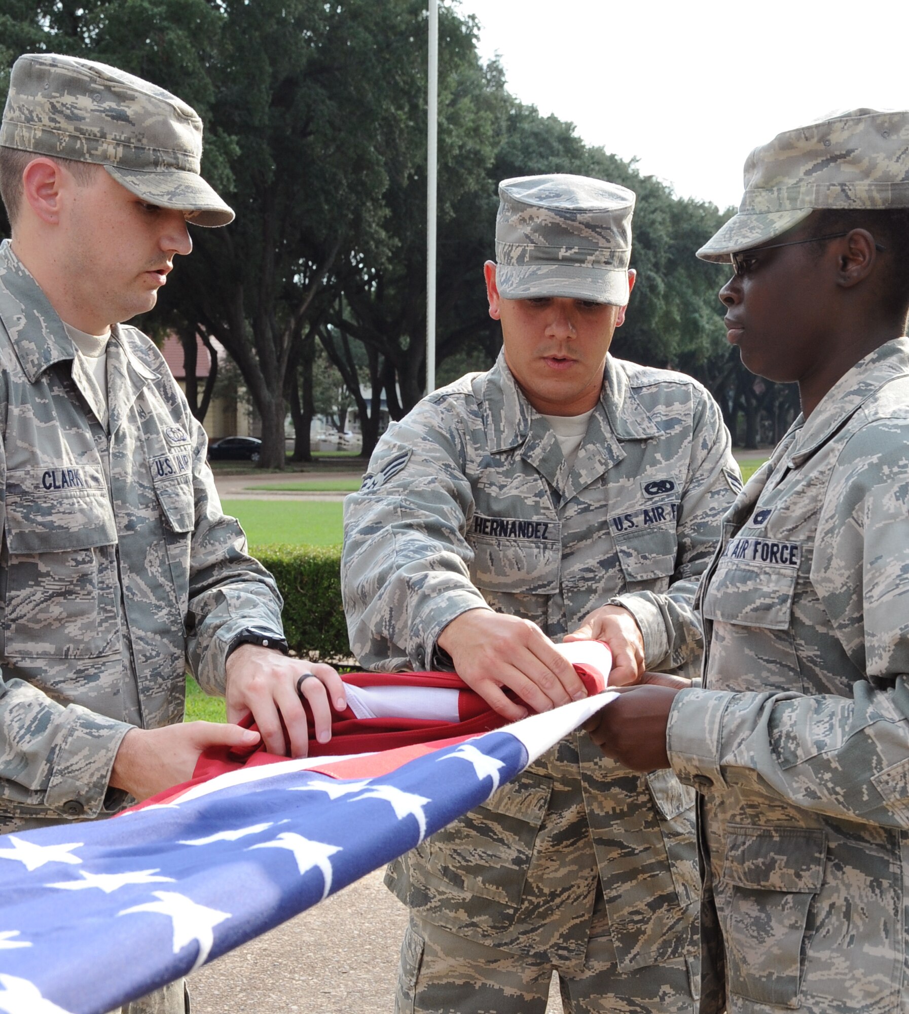 Airmen from Airman Leadership School class 12-6 fold the American flag during a retreat ceremony on Barksdale Air Force Base, La., Sept. 18. The ALS Airmen performed retreat in honor of the Air Force's 65th birthday. This was the first time an ALS class performed retreat for the 2nd Bomb Wing. (U.S. Air Forces photo/Airman 1st Class Benjamin Gonsier)(RELEASED)
