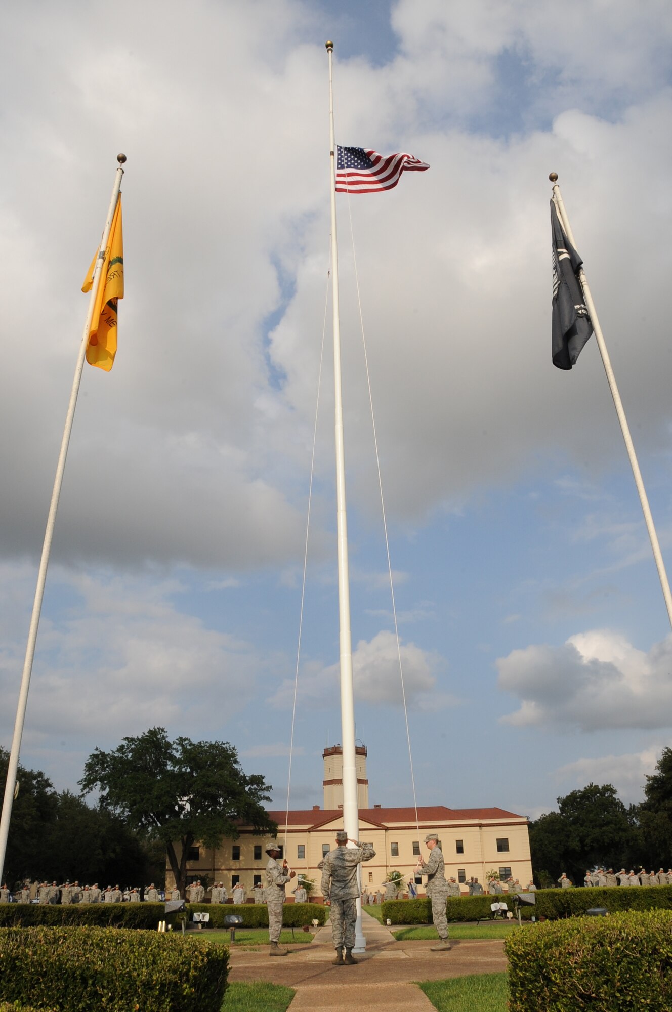 Airmen from Airman Leadership School class 12-6 lower the American flag during a retreat ceremony on Barksdale Air Force Base, La., Sept. 18. The flag detail consists of two halyards to lower the flag and two Airmen to salute and grab the flag before it touches the ground. This was the first time an ALS class performed retreat for the 2nd Bomb Wing. (U.S. Air Force photo/Airman 1st Class Benjamin Gonsier)(RELEASED)