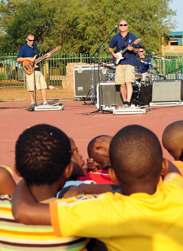 CULLINAN, South Africa -- The U.S. Air Forces in Europe rock band, Touch 'n Go, performs a concert as children from the local community watch here, Sept. 18. Touch ‘n Go is here as part of a group of Soldiers, Sailors, Airmen and Marines supporting the Africa Aerospace and Defense Trade show at Air Force Base Waterkloof from Sept. 19-23. As part of their stay, the band visited local communities strengthening the partnership between South Africa and the United States. (U.S. Air Force photo by Staff Sgt. Debbie Lockhart)