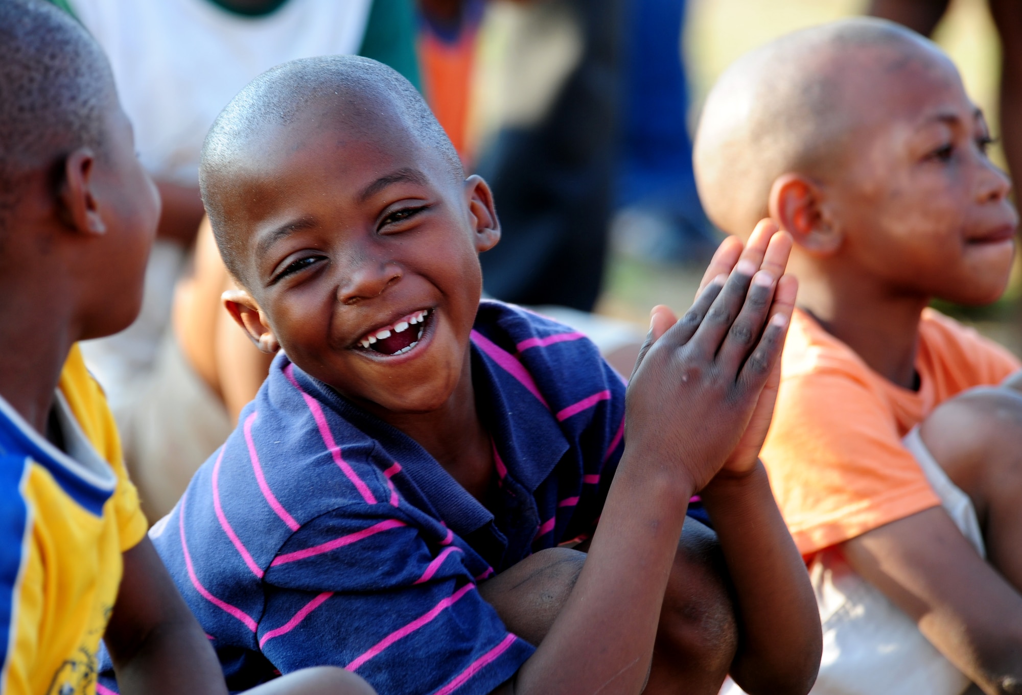 CULLINAN, South Africa -- A student from the Field Band Foundation's De Beers PPC Cullinan Field Band applauds as the U.S. Air Forces in Europe rock band, Touch 'n Go performs a concert for the local community here, Sept. 18. The Field Band Foundation is a private organization that has a goal of educating children within the local community on making good decisions, creativity, music and dance and other important life skills. The foundation aims to keep children away from negative influences and encourage them to be successful in life. (U.S. Air Force photo by Staff Sgt. Debbie Lockhart)