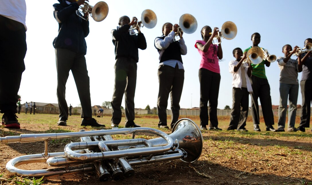 CULLINAN, South Africa -- Members of the De Beers PPC Cullinan Field Band rehearse before a performance from Touch 'n Go, the U.S. Air Forces in Europe rock band, here, Sept. 18. The Field Band Foundation is a private organization that has a goal of educating children within the local community on making good decisions, creativity, music and dance and other important life skills. Touch 'n Go helped attract attention to the foundation which aims to keep children away from negative influences and encourage them to be successful in life. (U.S. Air Force photo by Staff Sgt. Debbie Lockhart)