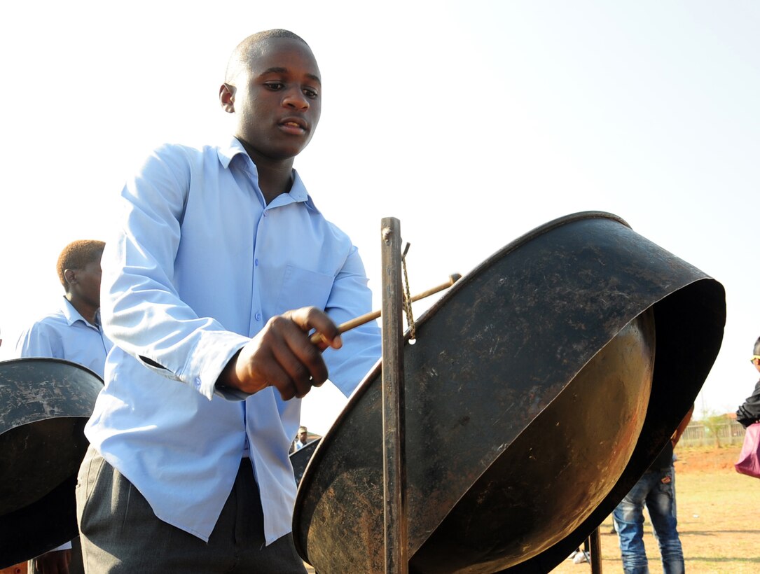 CULLINAN, South Africa -- Enoch Rumo, Cullinan Field Band melody steel drumer, rehearses before a performance from Touch 'n Go, the U.S. Air Forces in Europe rock band, here, Sept. 18. The Field Band Foundation is a private organization that has a goal of educating children within the local community on making good decisions, creativity, music and dance and other important life skills. Touch 'n Go helped attract attention to the foundation which aims to keep children away from negative influences and encourage them to be successful in life. (U.S. Air Force photo by Staff Sgt. Debbie Lockhart)
