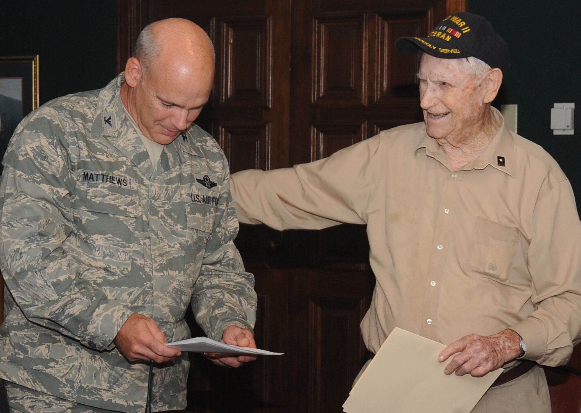 Col. Patrick Matthews, 2nd Mission Support Group commander, speaks with Claude McCrocklin, an Army Air Corps bombardier, during an informal luncheon on Barksdale Air Force Base, La., Sept. 19. McCrocklin, now 91, enlisted into the Army Air Corps on Barksdale in 1942. He spoke to members of Team Barksdale about his time as a Prisoner of War during World War II. (U.S. Air Force photo/Senior Airman Kristin High)(RELEASED)
