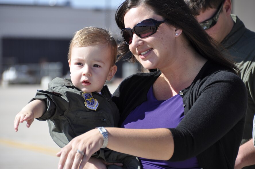 Shannon Sloger points to a taxiing C-130 on the Peterson Air Force Base ramp with her son, Brennan. Both were awaiting the return of Maj. Jeremy Sloger, a C-130 navigator with the 52nd Airlift Squadron. Approximately 25 members of the 52nd AS returned to Peterson Air Force Base, Sept. 14, after a 120-day deployment to Bagram Airfield, Afghanistan where the Air Force Reserve associate squadron aircrews and aircraft maintainers provided tactical airlift support to ground forces operating in Afghanistan. (U.S. Air Force photo/Ann Skarban) 