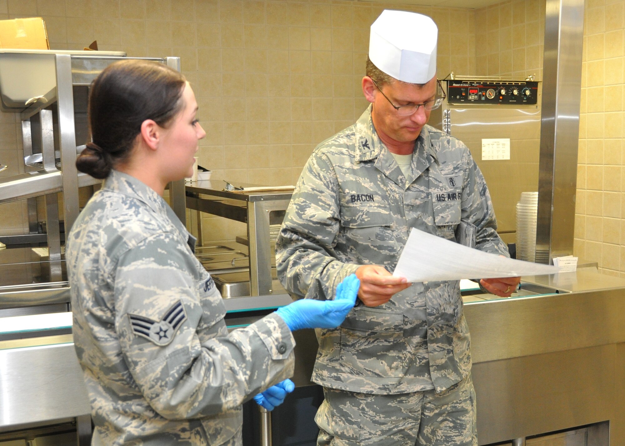 Senior Airman Anna Jeffers, a nutrition care specialist with the 81st Diagnostics and Therapeutics Squadron Nutritional Medicine Flight, explains the operation of the flight’s patient tray area to new squadron commander Col. Thomas Bacon July 24, 2012, at Keesler Air Force Base, Miss.  The section is responsible for preparing meal trays for patients on the inpatient units.  Bacon took command of the squadron from Col. Richard McBride July 17.  Prior to his current assignment, Bacon commanded the 81st MDTS at Vance AFB, Okla.  McBride left Keesler to become director of the Armed Services Blood Program Office in Fairfax County, Va. (U.S. Air Force photo by Steve Pivnick)
