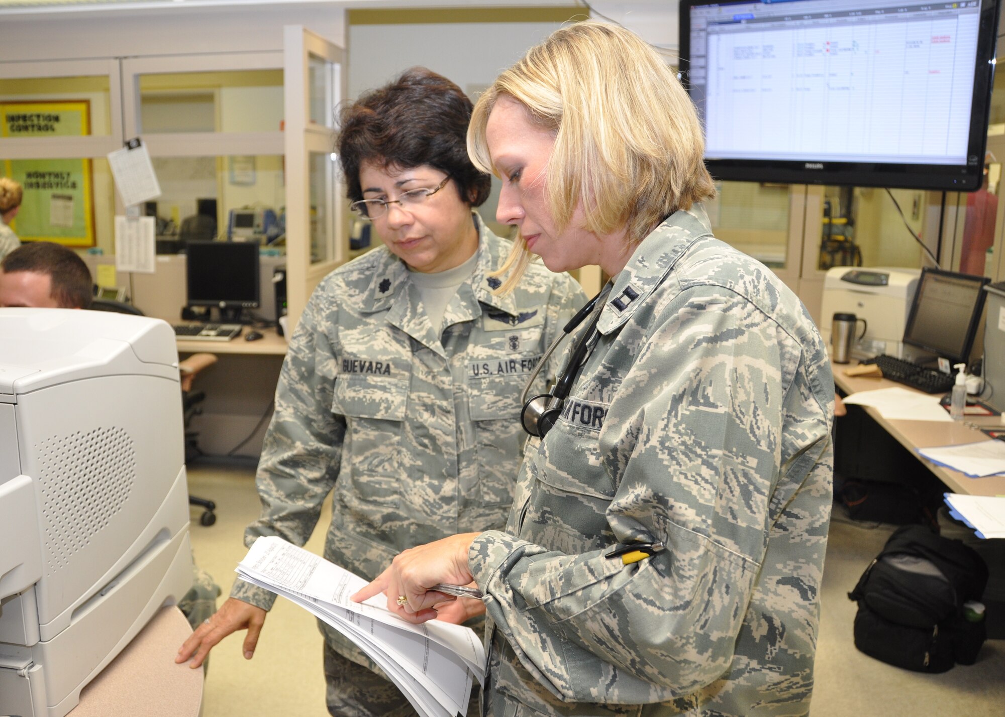 Lt. Col. Maria Guevara, new 81st Medical Operations Squadron commander, left, reviews the daily emergency department report with ER nurse Capt. Nancy Vansandt Aug. 21, 2012, at the Keesler Hospital, Keesler Air Force Base, Miss.  Guevara assumed command of the squadron July 18 from Col.  Julia Stoshak who had led the unit since August 2010.  The new commander comes to Keesler AFB after completing a year of Air War College at Air University, Maxwell AFB, Ala.  In her prior assignment, she was the chief, Aeromedical Evacuation Control Team Division, 617th Air and Space Operation Center, Ramstein Air Base, Germany.  Stoshak has a new assignment at Andrews AFB, Md.  (U.S. Air Force photo by Steve Pivnick)