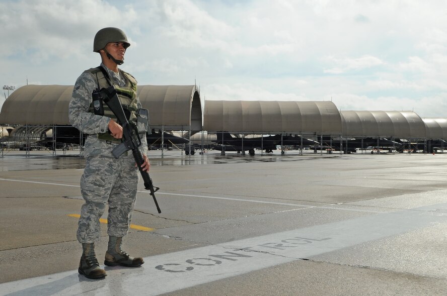 U.S. Air Force Airman 1st Class Jose Lurita-Sanchez, 4th Medical Support Squadron pharmacy technician, guards an entry to the flight line on Seymour Johnson Air Force Base, N.C., Sept. 18, 2012. Lurita-Sanchez, along with other security forces personnel and augmentees, ensure anyone attempting to enter the flight line has proper identification. (U.S. Air Force photo/Airman 1st Class Aubrey Robinson/Released) 