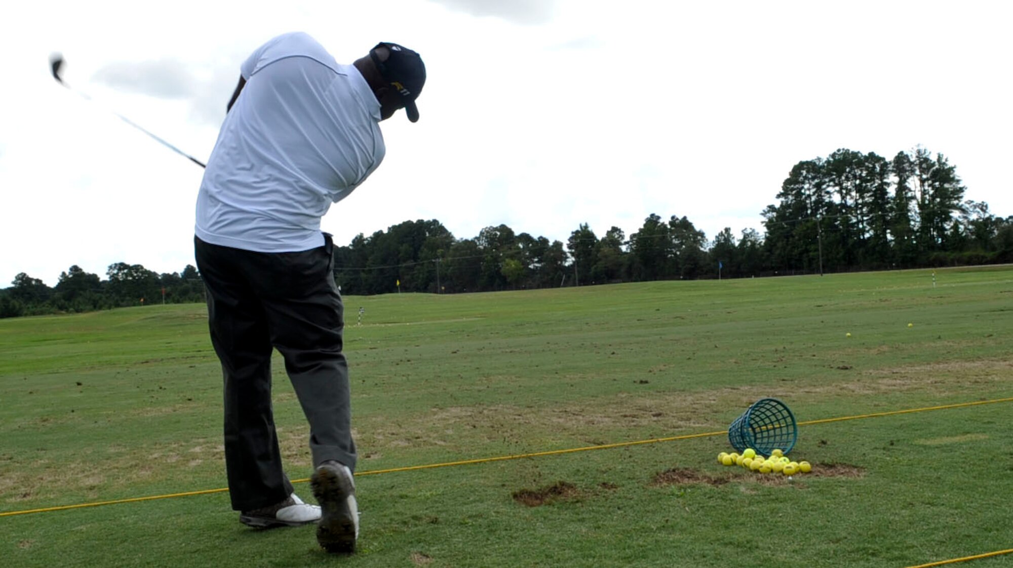 U.S. Army Sgt. James E. Robinson Jr., a graduate of the Warrior Transition Unit Golf Program, practices his driving at the Pines Golf Course at Fort Eustis, Va., Sept. 13, 2012. Robinson, who suffered a back injury while serving in Korea, said the program taught him patience, making his rehabilitation easier and proving that he could still play the game he loves. (U.S. Air Force photo by Staff Sgt. Wesley Farnsworth/Released)