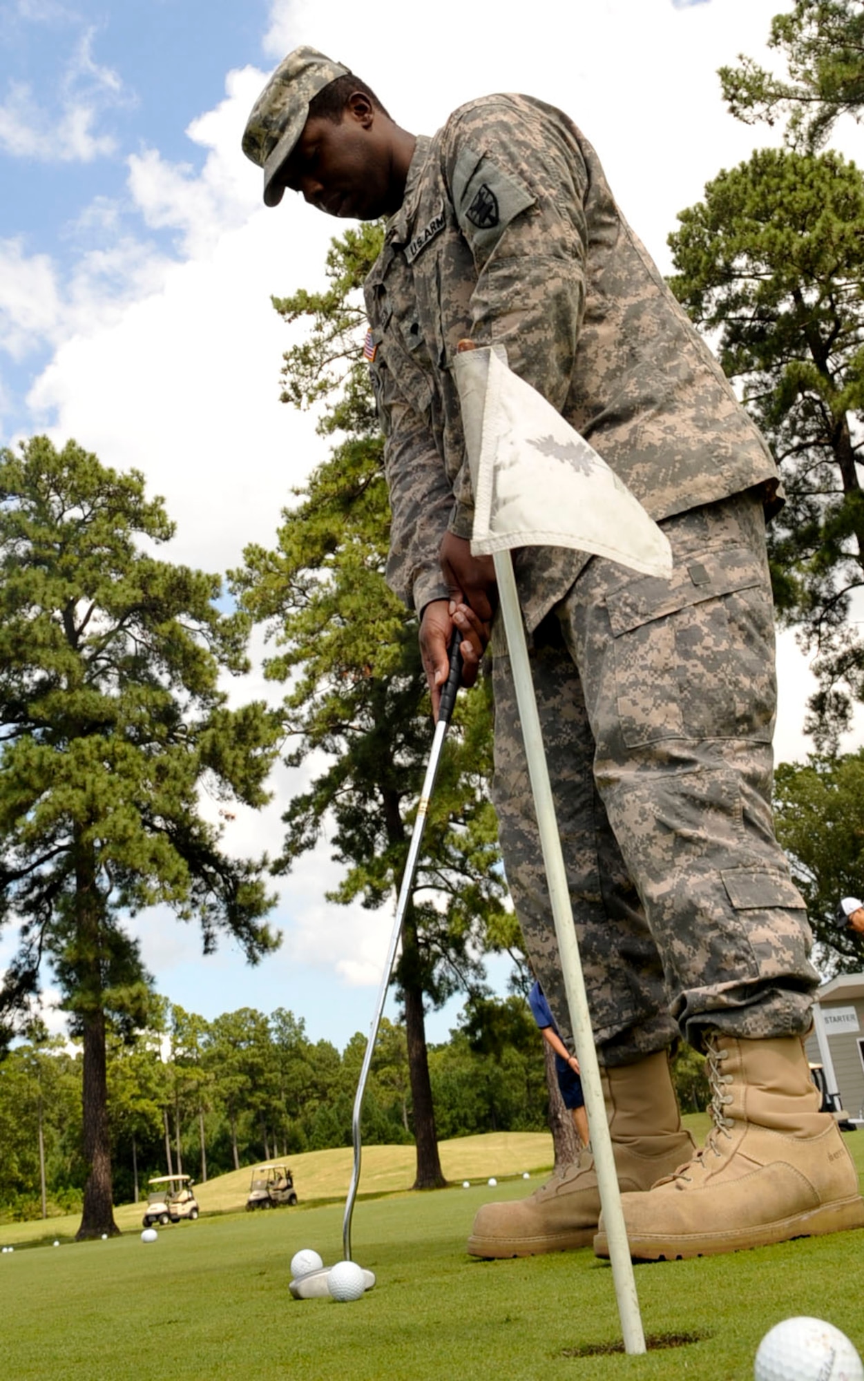 U.S. Army Spc. Jose Green practices putting as part of the Warrior Transition Unit Golf Program at the Pines Golf Course on Fort Eustis, Va., Sept. 13, 2012. Green, a wounded warrior assigned to Eustis' WTU, said he looks forward to playing a round of golf with his father and grandfather when he completes the program. (U.S. Air Force photo by Staff Sgt. Wesley Farnsworth/Released)