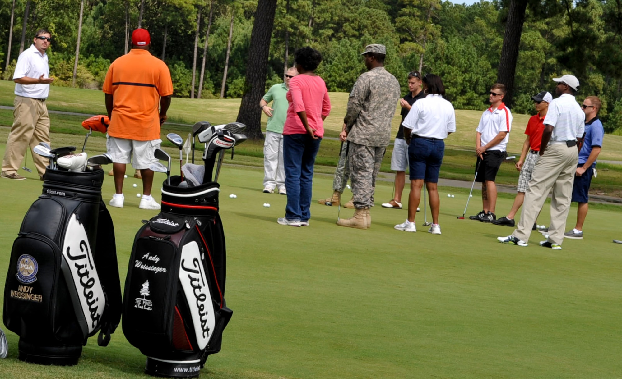Andy Weissinger, (far left), a Professional Golfers Association of America instructor, provides putting instruction to Soldiers participating in the Warrior Transition Unit Golf Program at the Pines Golf Course on Fort Eustis, Va., Sept. 13, 2012. The eight-week course is designed to teach wounded warriors how to successfully play the game within their capabilities, using specialized equipment and methods. (U.S. Air Force photo by Staff Sgt. Wesley Farnsworth/Released)