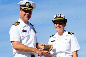 Ensign Donna Purviance receives the Vice Admiral Behrens award for Officer Class 1203 from Capt. Jon Fahs, Naval Nuclear Power Training Command commanding officer, during the NNPTC graduation ceremony Sept 14, 2012, at Joint Base Charleston - Weapons Station, S.C. The Behrens award is given to the officer with the highest grade point average. Purviance's grade point average was 3.79. (U.S. Air Force photo/ Airman 1st Class Chacarra Walker)