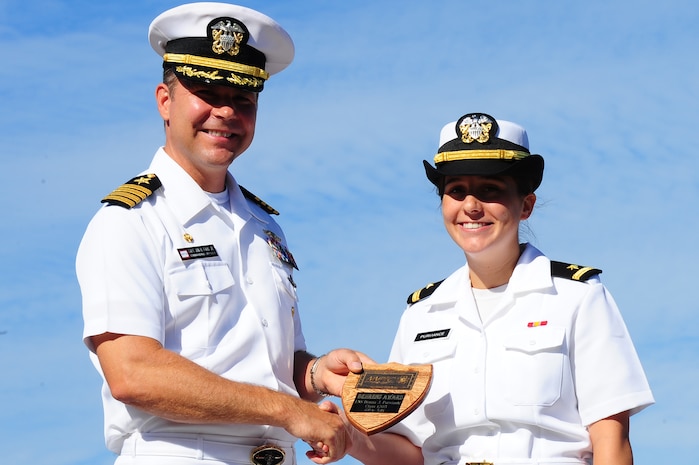 Ensign Donna Purviance receives the Vice Admiral Behrens award for Officer Class 1203 from Capt. Jon Fahs, Naval Nuclear Power Training Command commanding officer, during the NNPTC graduation ceremony Sept 14, 2012, at Joint Base Charleston - Weapons Station, S.C. The Behrens award is given to the officer with the highest grade point average. Purviance's grade point average was 3.79. (U.S. Air Force photo/ Airman 1st Class Chacarra Walker)