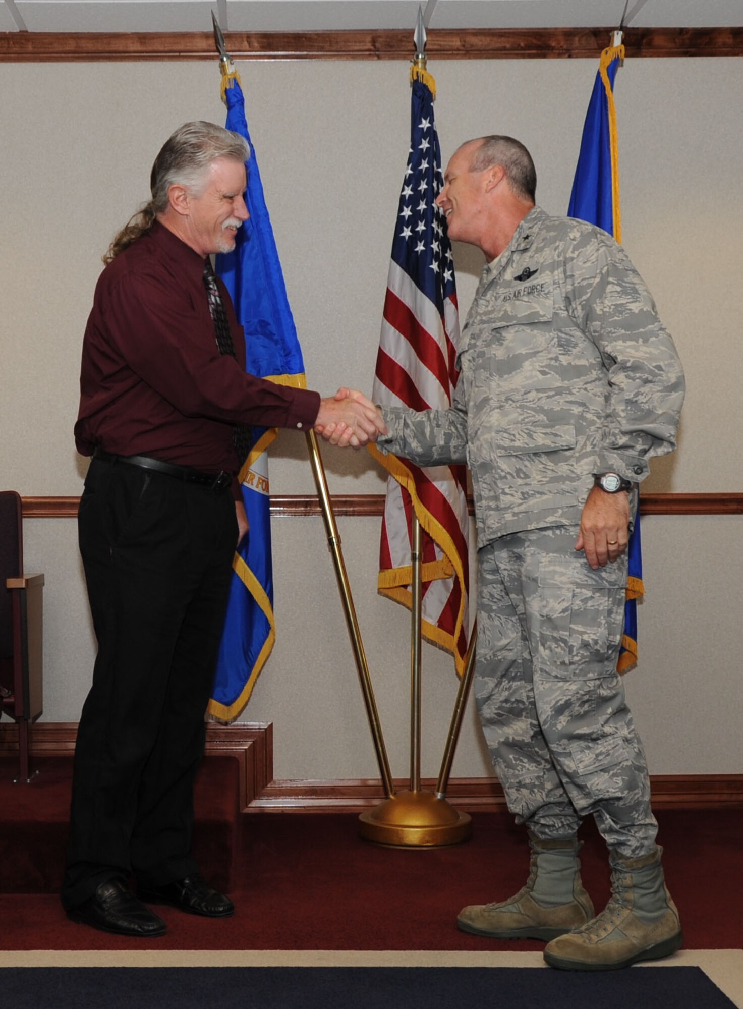 Brig. Gen. Michael Fantini, 82nd Training Wing commander, presents a coin to James Getchell,82nd Force Support Squadron, for being named the 82nd TRW "Commander's Wingman of Choice" award winner Sep. 19, 2012 during the wing staff meeting.  The award is presented weekly for outstanding duty performance, community involvement and exemplary leadership of Team Sheppard members. (U.S. Air Force photo/Joshua Felton)