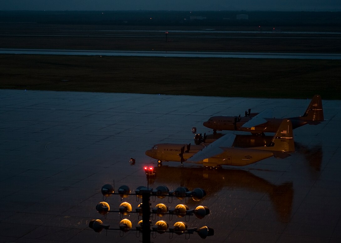 C-130J Super Hercules from the 317th Airlift Group sit on the flightline during a storm Sept. 18, 2012, at Dyess Air Force Base, Texas. Dyess recently received its 23rd of 28 C-130Js. Once the final aircraft is delivered, Dyess will be home to the largest C-130J fleet in the world. (U.S. Air Force photo by Airman 1st Class Damon Kasberg/ Released)