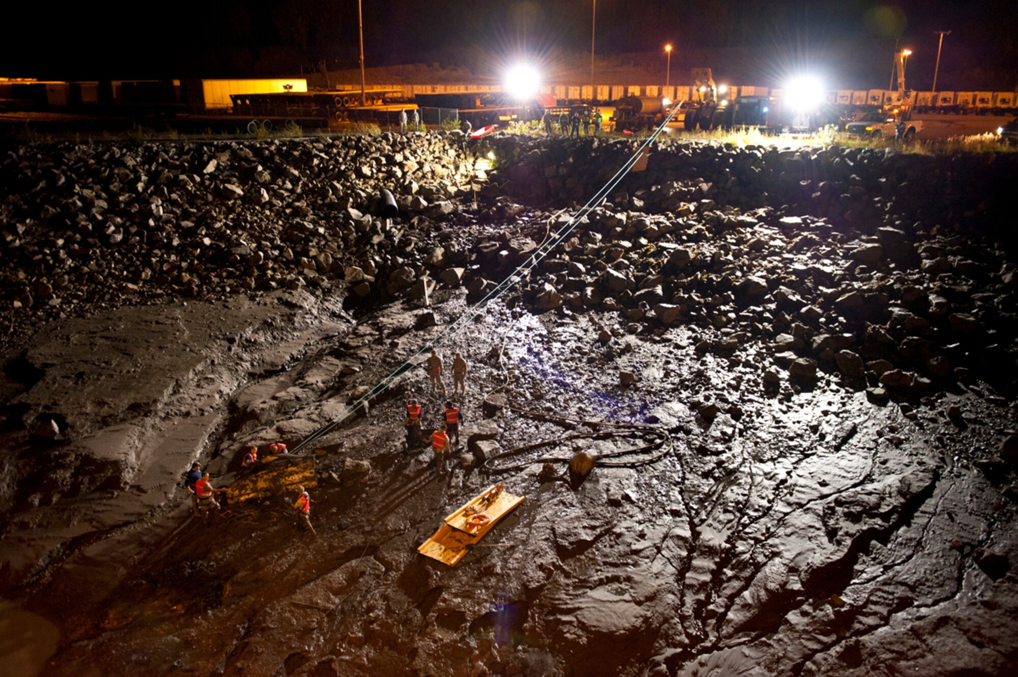 JOINT BASE ELMENDORF-RICHARDSON, Alaska --  Airmen from the JBER Crash Recovery Unit dig out the entrenched F-4 Phantom fuel tank from the Port of Anchorage, Sept. 18, 2012. JBER and the Port of Anchorage worked together to safely remove the external fuel tank, which was discovered earlier by Port personnel. F-4s were flown at Elmendorf Air Force Base through 1982. (U.S. Air Force Photo/Airman 1st Class Omari Bernard)
