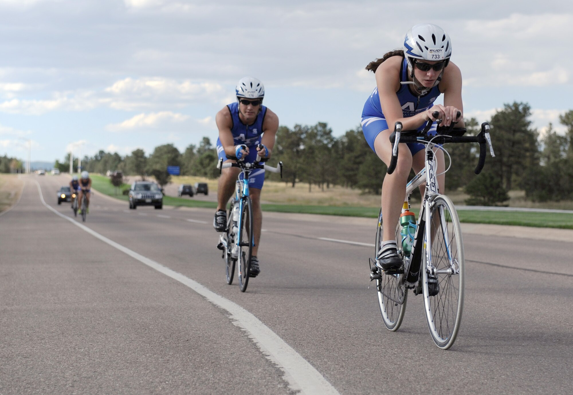 Cadets 3rd Class Erin Crow (right) and James Carney grind out miles on Stadium Boulevard at the Air Force Academy Sept. 4, 2012. Cadet Triathlon Team members will travel 80-100 miles on bicycles each weekend as part of their triathlon training. (U.S. Air Force photo/John Van Winkle)