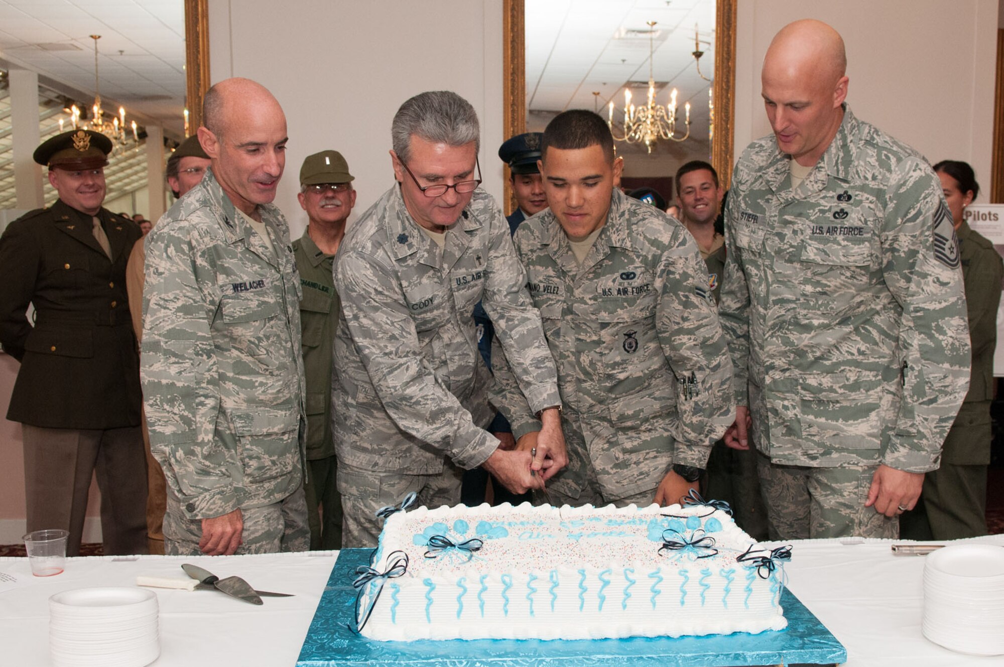 HANSCOM AIR FORCE BASE, Mass. – Chaplain (Lt. Col.) Kevin Cody (second from left), Hanscom’s oldest Airman, and Airman 1st Class Pedro Serrano Velez, Hanscom youngest Airman, cut the Air Force birthday cake as Col. Lester A. Weilacher, 66th Air Base Group commander, and Chief Master Sgt. Baird Stiefel, Hanscom senior enlisted advisor, stand by during a birthday day celebration in the Minuteman Commons Sept. 18. In addition to the cake cutting ceremony, attendees were entertained with an Air Force uniform fashion show and music by the Band of Liberty. (U.S. Air Force photo by Rick Berry)