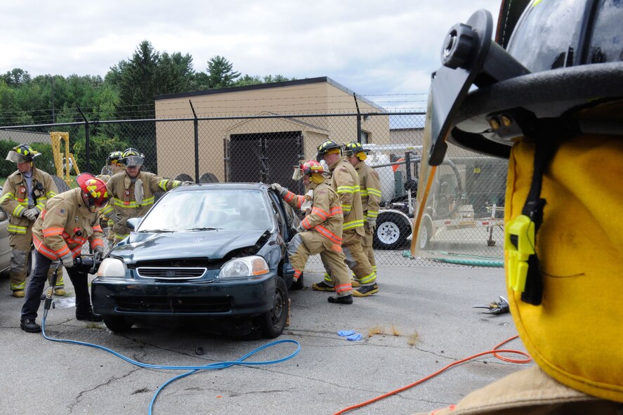 HANSCOM AIR FORCE BASE, Mass. – Hanscom firefighters use the “jaws of life” during a simulated motor vehicle accident in the civil engineering compound Sept. 10. The Hanscom Fire Department participates in exercises such as these to be better prepared for real world situations. (U.S. Air Force photo by Linda LaBonte Britt)