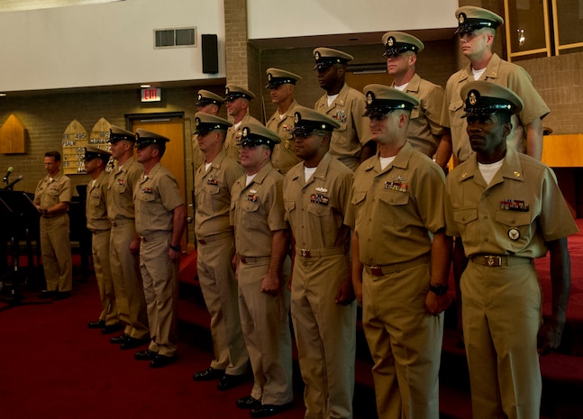 Fourteen newly-pinned chief petty officers stand at attention during a chief pinning ceremony Sept. 14, 2012 at Joint Base Charleston - Weapons Station . There were 4,381 active duty chief petty officers selected for promotion fiscal year 2013. (U.S. Air Force photo/Airman 1st Class George Goslin)