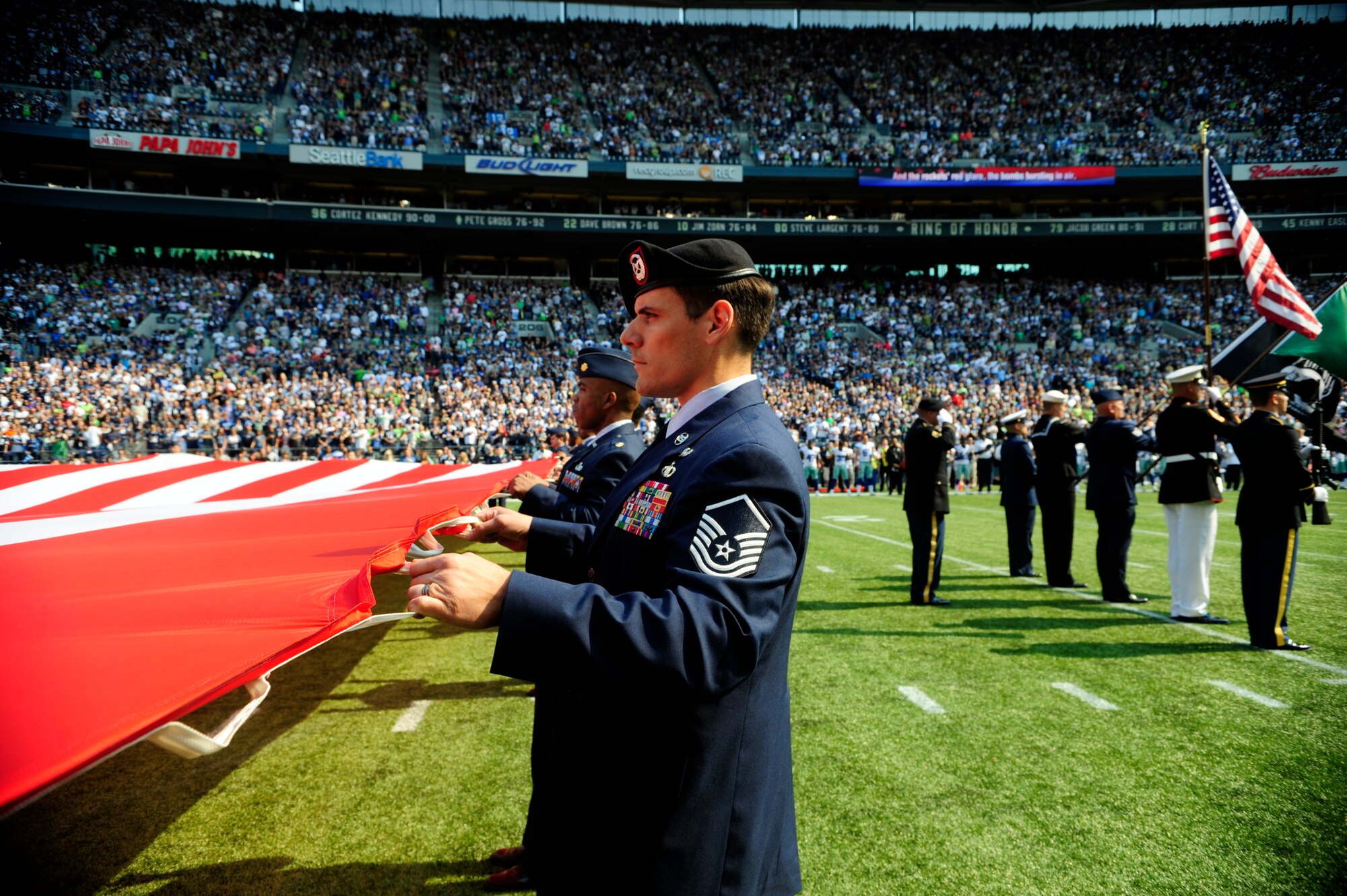 Master Sgt. Mark Kistler, 22nd Special Tactics Squadron flight superintendent, tightly holds the U.S. flag for the pregame ceremonies at the Sept. 16, 2012 Seattle Seahawks home opener against the Dallas Cowboys at Century Link field in Seattle, As a tenant unit to the 62nd Airlift Wing at Joint Base Lewis-McChord, Wash., the 22nd STS provided three servicemembers to assist with the pregame ceremonies.  (U.S. Air Force photo/Master Sgt. Todd Wivell)