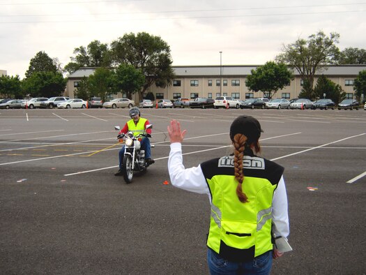 Michael Ballard, Air Force Ground Safety Operations Branch chief, operates a motorcycle per instructions of Master Sgt. Bonnie Steinmetz, an instructor candidate, during the Motorcycle Safety Foundation’s RiderCoach Preparatory Training course held Sept. 7-13 at Kirtland AFB, N.M. (U.S. Air Force photo by Mike Wolcott)
