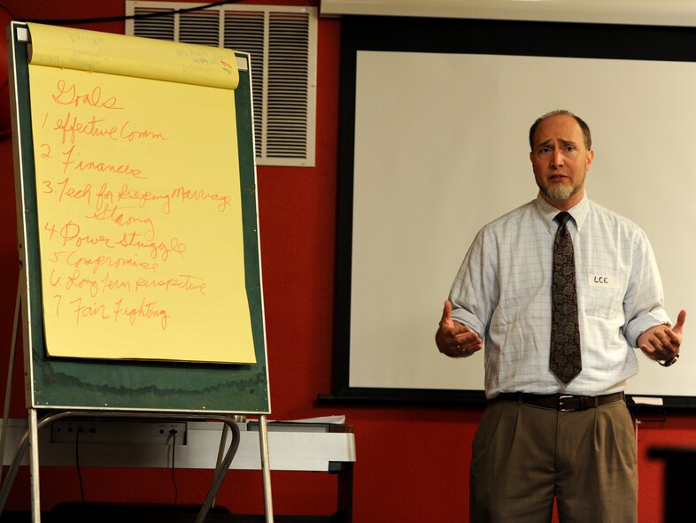 Lee Sassy, 28th Medical Operations Squadron Mental Health Clinic Family Advocacy Outreach manager, speaks to couples about managing finances during the “So You Thought Marriage Would Be Easy” social event in the Higher Grounds at Ellsworth Air Force Base, S.D., Sept. 13, 2012. Couples who attended the social mingled, learned about healthy family relationships and received a better understanding about the many support resources available at Ellsworth. (U.S. Air Force photo by Airman 1st Class Hrair H. Palyan/Released)
