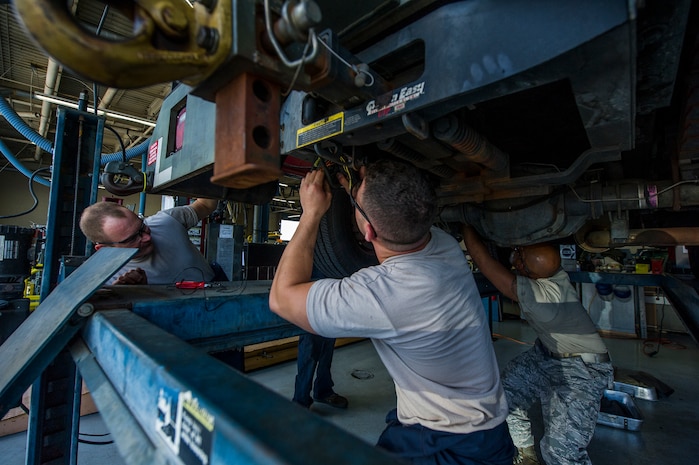 Airmen from the 628th Logistics Readiness Squadron vehicle maintenance shop troubleshoot the cause of malfunctioning lights on a vehicle Sept. 6, 2012, at Joint Base Charleston - Air Base, S.C. Vehicle maintenance technicians maintain JB Charleston's entire vehicle fleet, keeping cars, trucks and buses operating smoothly. (U.S. Air Force photo/Airman 1st Class George Goslin)