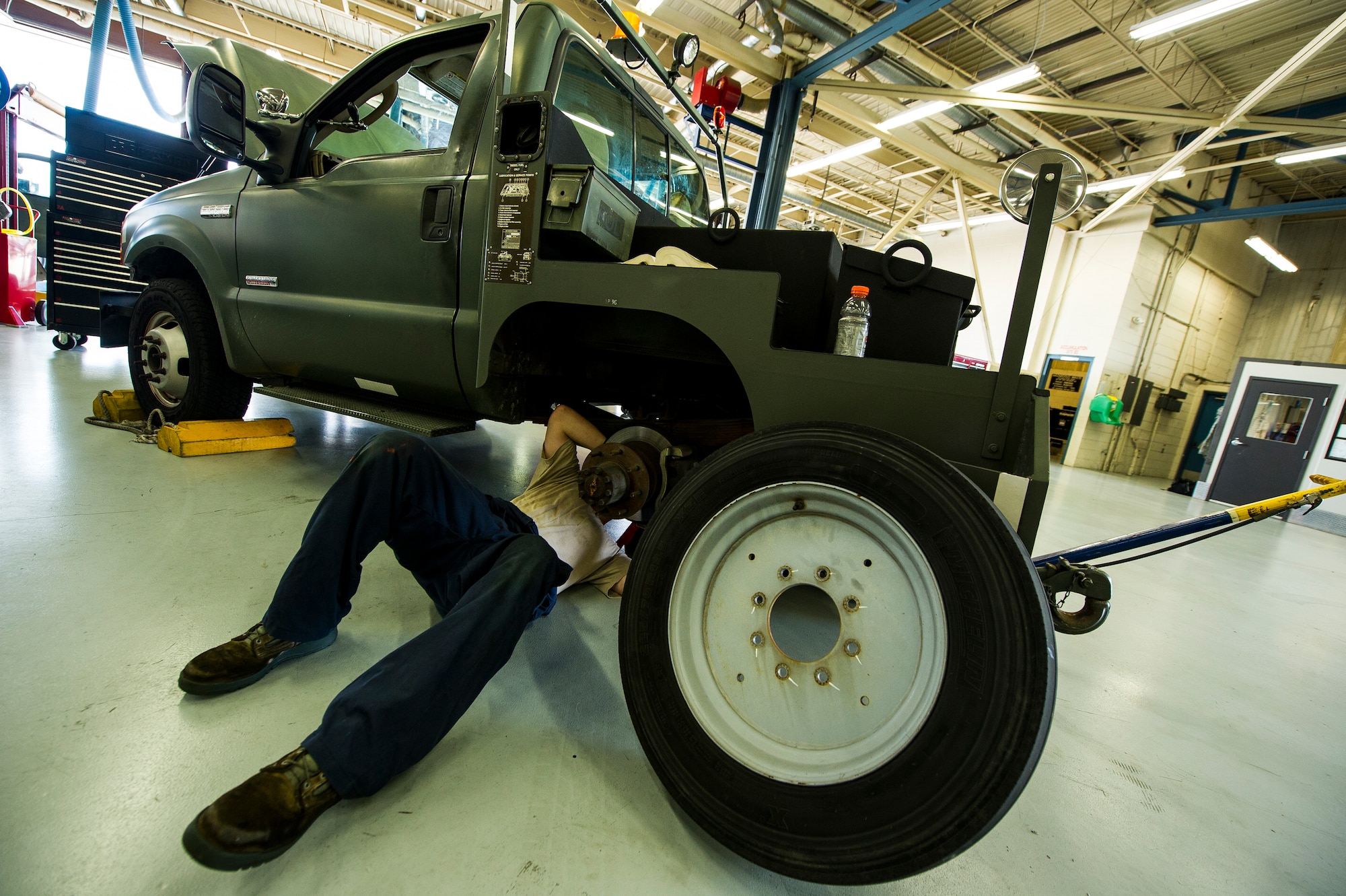 Senior Airman Benjamin Kingston, 628th Logistics Readiness Squadron vehicle maintenance technician, adjusts the parking brake on a vehicle during routine vehicle maintenance Sept. 6, 2012, at Joint Base Charleston - Air Base, S.C. Vehicle maintenance technicians maintain JB Charleston's entire vehicle fleet, keeping cars, trucks and buses operating smoothly. (U.S. Air Force photo/Airman 1st Class George Goslin)