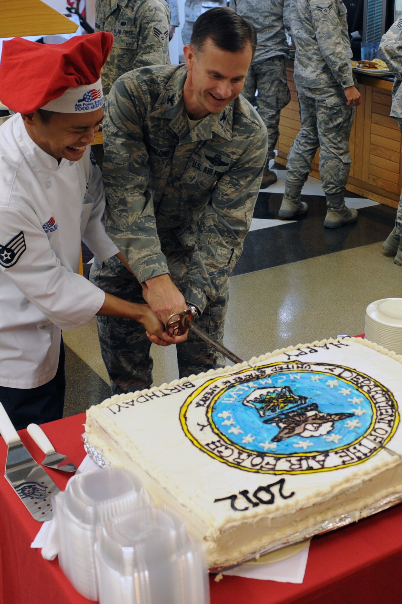 WHITEMAN AIR FORCE BASE, Mo., --  Col. Robert Spalding, 509th Bomb Wing vice commander, and Staff Sgt. Jerry Calalang, 509th Force Support Squadron, perform the cake cutting ceremony to celebrate Air Force?s 65th birthday, Sept. 18.  (U.S. Air Force photo/Staff Sgt. Jason Huddleston) (Released)