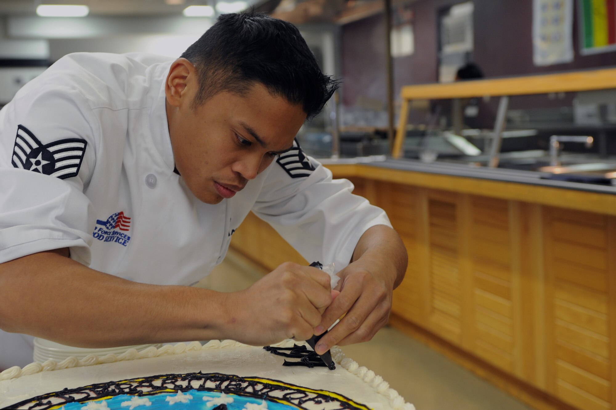 WHITEMAN AIR FORCE BASE, Mo., -- Staff Sgt. Jerry Calalang 509th Force Support Squadron dining facility food service supervisor, puts the finishing touches on the birthday cake he made in celebration of the Air Force's 65th birthday, Sept. 18. (U.S. Air Force photo/Staff Sgt. Jason Huddleston) (Released)
