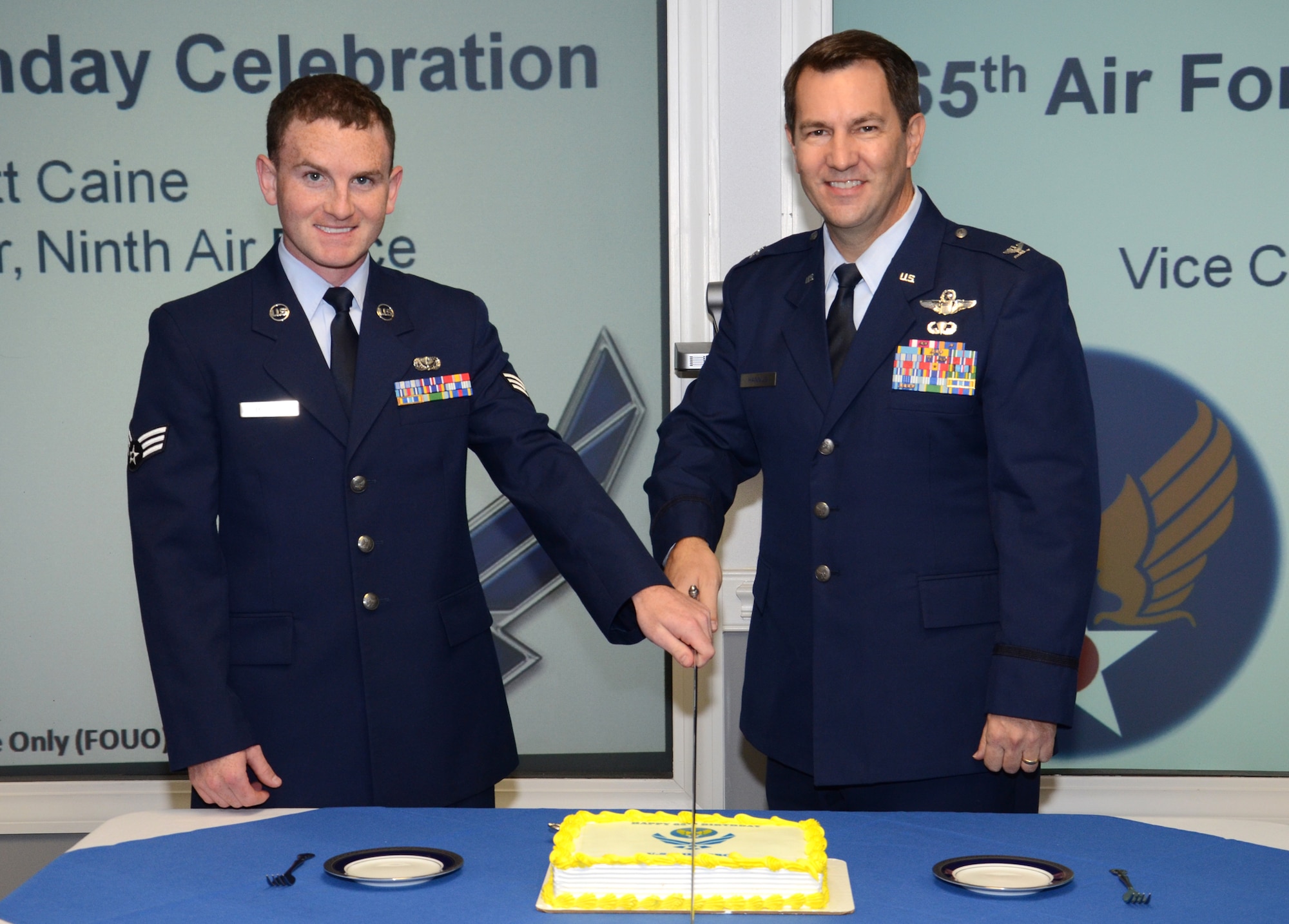 Two 9th Air Force Airmen, Senior Airman Ryan Broach, protocol specialist, and Col. Timothy Hannus, director of operations, cut a cake during a celebration of the Air Force’s 65th birthday Sept. 18, 2012, at Shaw Air Force Base, S.C. The gentlemen represented the unit’s youngest and oldest available Airmen. The U.S. officially became an independent military branch Sept. 18, 1947. (U.S. Air Force photo by Staff Sgt. Amanda Currier/Released)