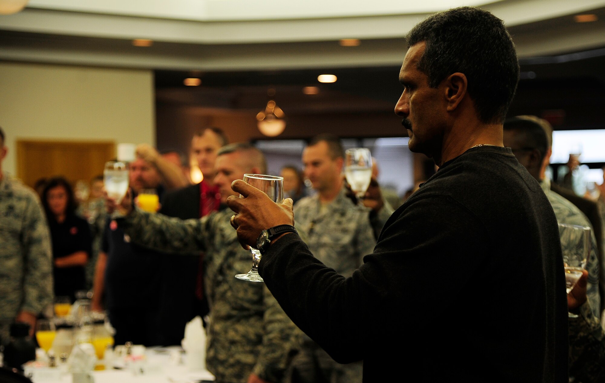 Edwin Rodriguez, retired chief and husband of Theresa Rodriguez, 509th Medical Group commander, raises his glass to toast those U.S. service members who have been prisoners of war or missing-in-action, during a POW/MIA breakfast at Whiteman Air Force Base, Mo., Sept. 14. More than 80,000 U.S., service members have been POW/MIAs throughout the past century. (U.S. Air Force photo/ Senior airman Cody H. Ramirez) (RELEASED)