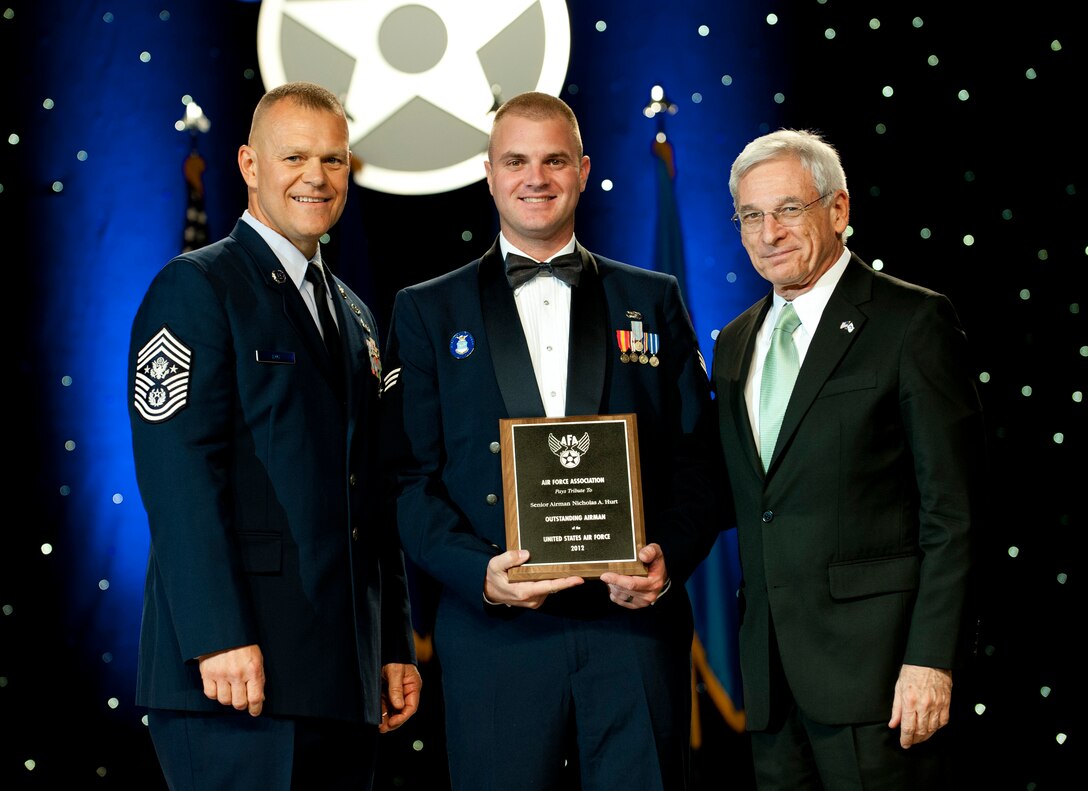 Chief Master Sgt. of the Air Force James Roy, left, and Sandy Schlitt, right, Air Force Association's chairman of the board, present a plaque to Senior Airman Nicholas Hurt during the 12 Outstanding Airmen of the Year reception and awards dinner in Washington, D.C., Sept. 17, 2012. The recipients were recognized for superior leadership, job performance, community involvement and personal achievements. Hurt is with the 721st Security Forces Squadron from Cheyenne Mountain Air Force Station, Colo. (U.S. Air Force photo/Jim Varhegyi)