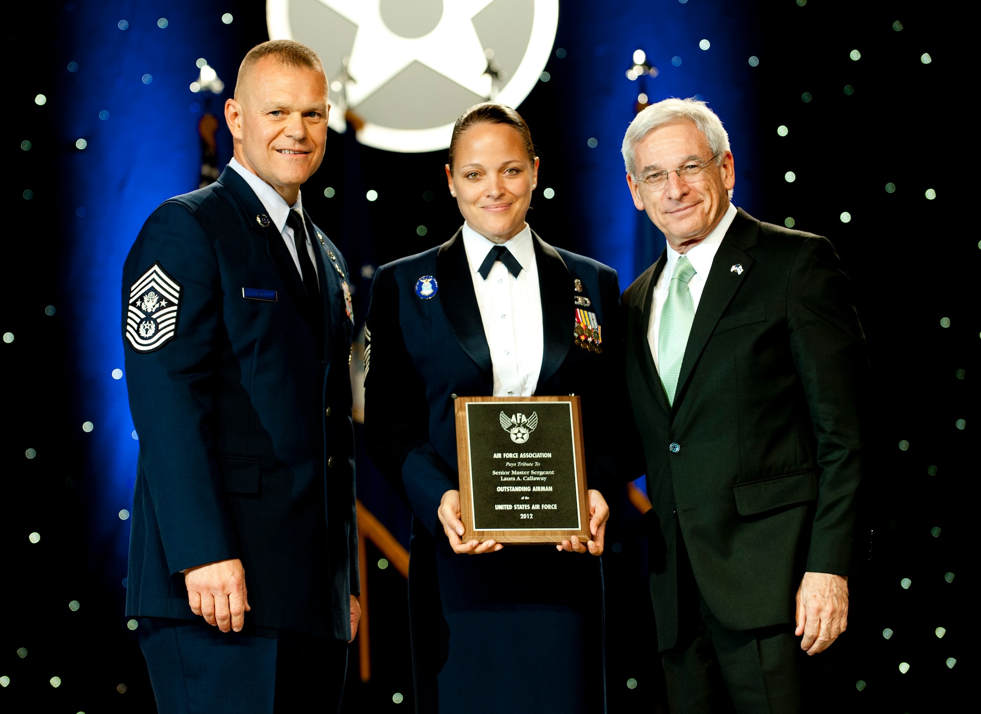 Chief Master Sgt. of the Air Force James Roy, left, and Sandy Schlitt, right, Air Force Association's chairman of the board, present a plaque to Senior Master Sgt. Laura Callaway during the 12 Outstanding Airmen of the Year reception and awards dinner in Washington, D.C., Sept. 17, 2012. The recipients were recognized for superior leadership, job performance, community involvement and personal achievements. Callaway is with the 60th Medical Operations Squadron from Travis Air Force Base, Calif. (U.S. Air Force photo/Jim Varhegyi)