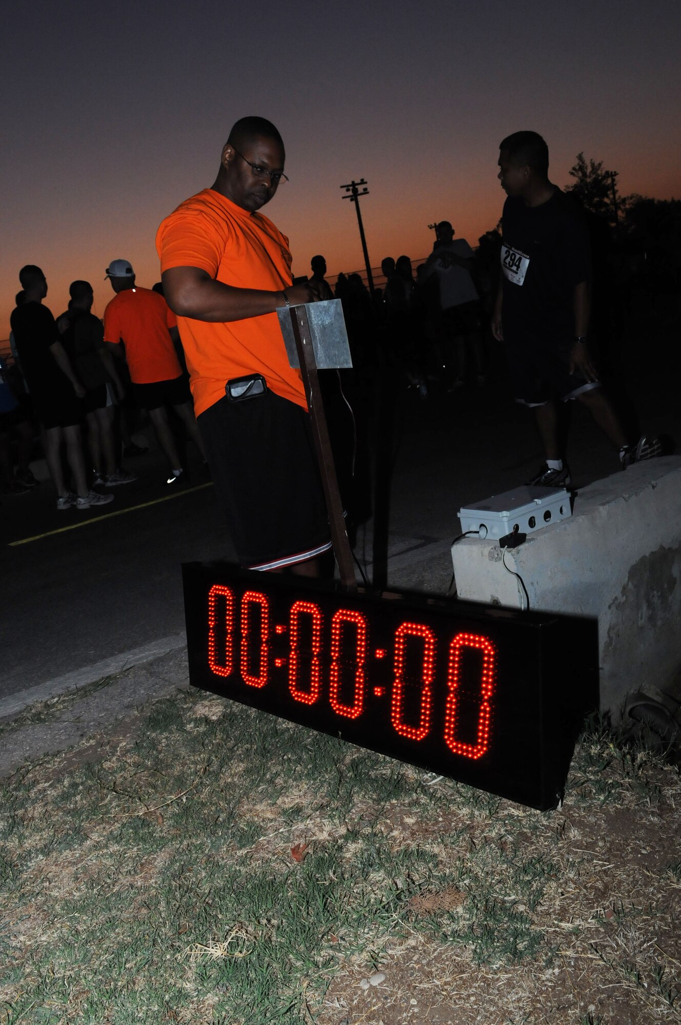 Master Sgt. Roy Robinson, 39th Force Support Squadron fitness center NCO in charge, ensures the timer is working correctly before the Incirlik Half Marathon Sept. 15, 2012, at Incirlik Air Base, Turkey. More than 80 people participated in the event, which coincided with the Air Force Marathon held at Wright-Patterson Air Force Base, Ohio. (U.S. Air Force photo by Senior Airman Marissa Tucker/Released)